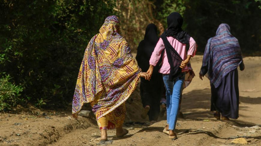 Sudanese women walk in the capital Khartoum's district of Jureif Ghar on May 5, 2020. - Sudan's cabinet approved amendments to the criminal code that would punish those who perform Female Genital Mutilation (FGM) with up to three years in prison and a fine. The practice has long been viewed, especially in rural communities, as a "rite of passage" for girls and a way to preserve their chastity. Rights groups have for years decried as barbaric the practise which can lead to myriad physical, psychological and 