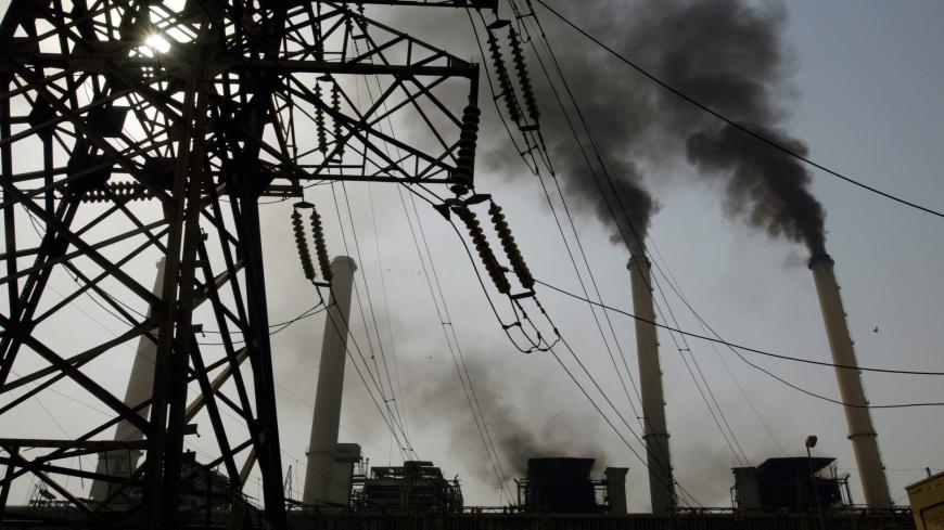 BAGHDAD, IRAQ -OCTOBER 11:  Black smoke pours out of the smoke stacks at the Al-Doura power plant in Baghdad, October 11, 2003. The outdated power grid damaged in the war and in months of sabotage is working at 25% of its capacity. Restoring electricity is costing of $5.7 billion , the biggest price tag in the Iraq reconstruction.  

(Photo by Paula Bronstein/Getty Images)
