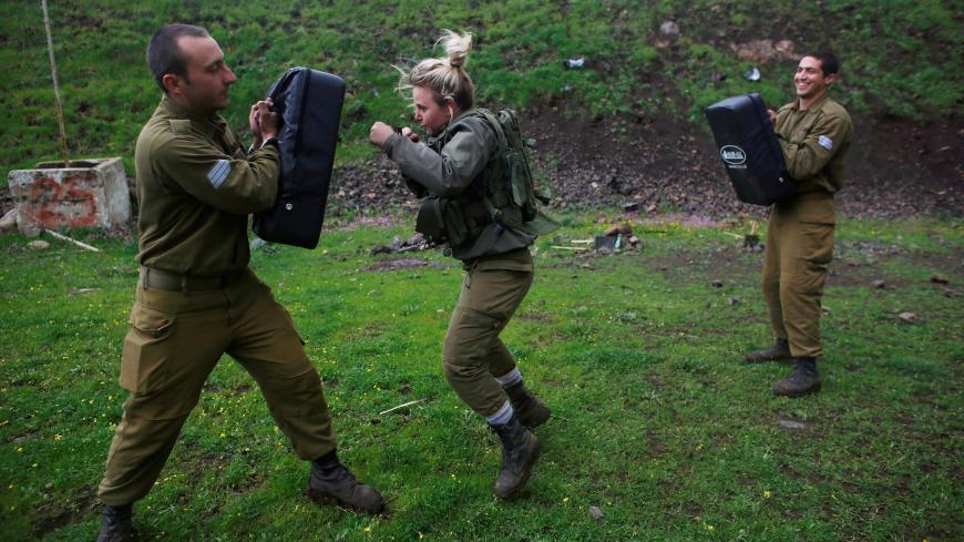 A female Israeli soldier from the Haraam artillery battalion takes part in a training session in Krav Maga, an Israeli self-defence technique, at a military base in the Israeli-occupied Golan Heights March 1, 2017. Picture taken March 1, 2017. REUTERS/Nir Elias - RC15DBEF26F0