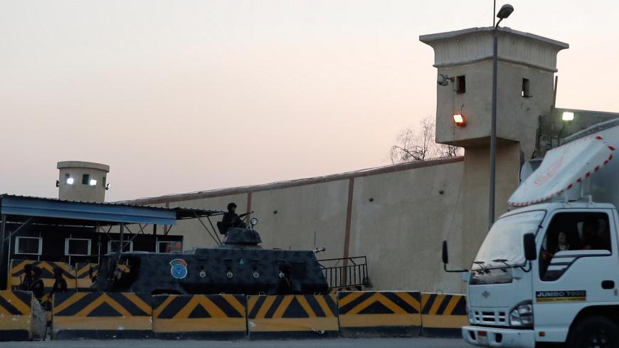A truck drives in front of security and riot police guards, outside Cairo's Tora prison, where the trial of ousted Egyptian Islamist President Mohamed Mursi took place, in Cairo, Egypt June 17, 2019. REUTERS/Amr Abdallah Dalsh - RC1F3A17E980