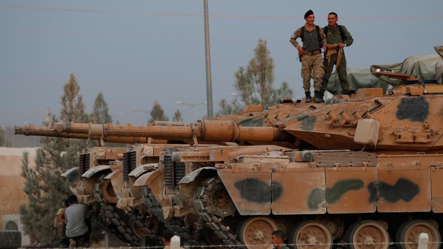 Turkish soldiers stand on top of a tank in the border town of Akcakale in Sanliurfa province, Turkey, October 11, 2019. REUTERS/Murad Sezer - RC146E7AC710