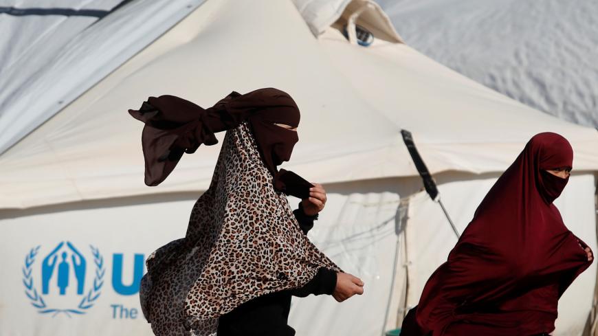 Women walk past a tent in al-Hol camp, Syria, January 8, 2020. REUTERS/Goran Tomasevic     SEARCH "ISLAMIC STATE PRISONERS" FOR THIS STORY. SEARCH "WIDER IMAGE" FOR ALL STORIES. - RC2YYE9CVKHM