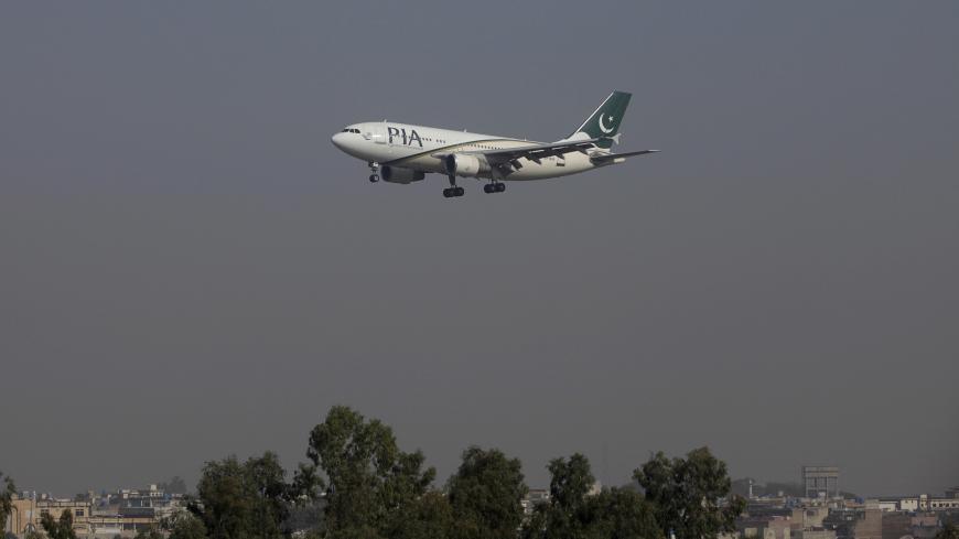 A Pakistan International Airlines (PIA) passenger plane arrives at the Benazir International airport in Islamabad, Pakistan, December 2, 2015. Employees of Pakistan's ailing national airline on December 15, 2015, walked out in protest over its planned privatisation, disrupting flights and undermining a central plank of reforms promised by Prime Minister Nawaz Sharif in return for an IMF bailout. Picture taken December 2, 2015. REUTERS/Faisal Mahmood - GF10000266349