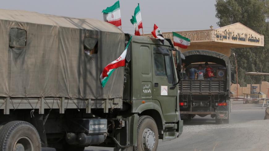 Iranian and Syrian flags flutter on a truck carrying humanitarian aid in Deir al-Zor, Syria September 20, 2017. Picture taken September 20, 2017. REUTERS/Omar Sanadiki - RC1C8E382200