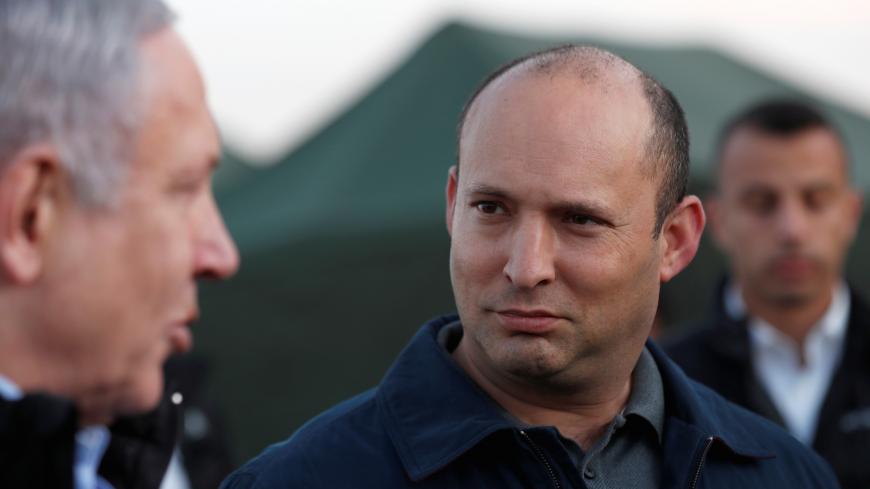 Israeli Defense Minister Naftali Bennett looks at Prime Minister Benjamin Netanyahu during a visit to an Israeli army base in the Israeli-occupied Golan Heights, November 24, 2019. Atef Safadi/Pool via REUTERS - RC2UHD9FXFTH