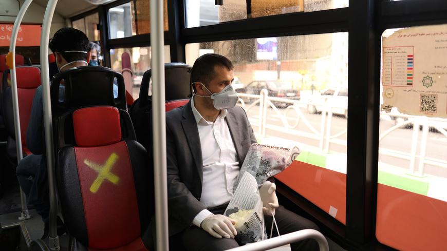 A man wears a protective face mask as he sits in a bus, following the outbreak of the coronavirus disease (COVID-19), after shopping malls and bazaars reopened in Tehran, Iran, April 20, 2020. WANA (West Asia News Agency)/Ali Khara via REUTERS ATTENTION EDITORS - THIS PICTURE WAS PROVIDED BY A THIRD PARTY - RC2F8G9K61IV