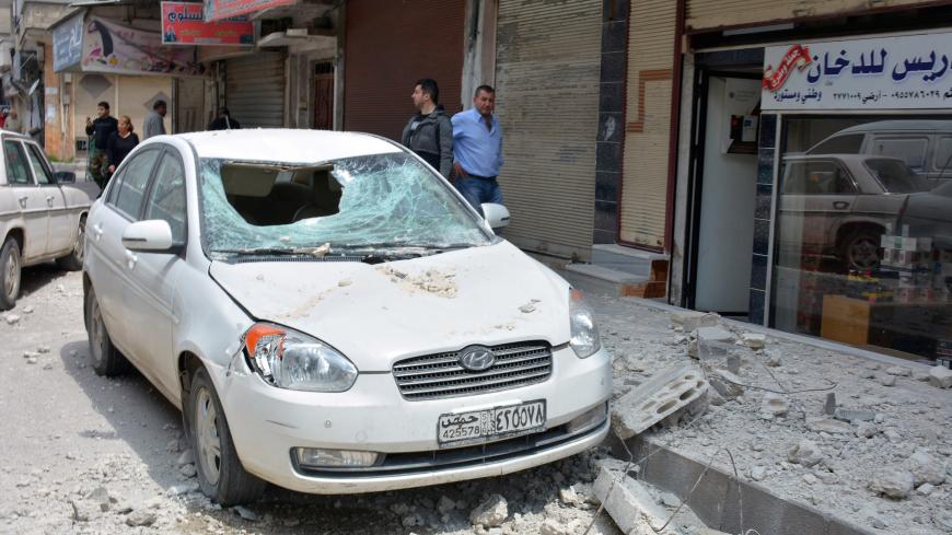 People inspect the damage after a blast east of Homs city, Syria in this handout released by SANA on May 1, 2020. SANA/Handout via REUTERS ATTENTION EDITORS - THIS IMAGE WAS PROVIDED BY A THIRD PARTY. REUTERS IS UNABLE TO INDEPENDENTLY VERIFY THIS IMAGE - RC2PFG9URBKH