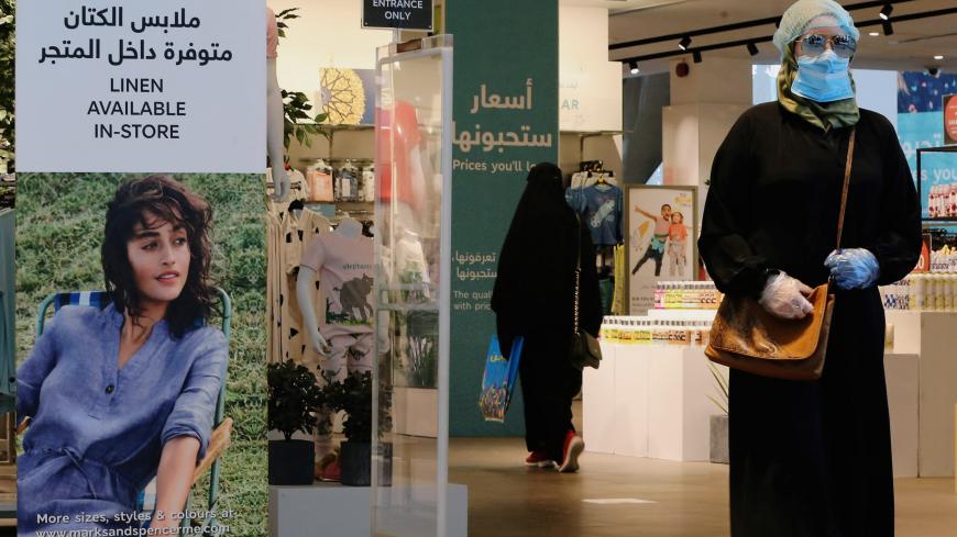 A woman wearing a protective mask walks at a shopping mall after the Saudi government eased a curfew and allowed stores to open, following the outbreak of the coronavirus disease (COVID-19), in Riyadh, Saudi Arabia May 2, 2020. REUTERS/Ahmed Yosri - RC2JGG9YJCK0