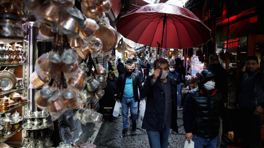 People wearing face masks shop at Eminonu district, amid the spread of the coronavirus disease (COVID-19), in Istanbul, Turkey, May 4, 2020. REUTERS/Umit Bektas - RC2PHG9O2XF1