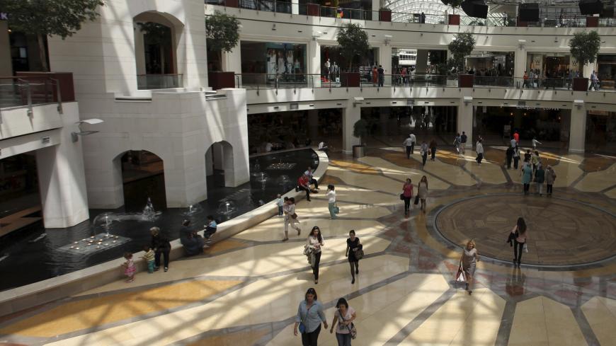 Shoppers walk in Istinye Park shopping mall in Istanbul May 17, 2013. Turkey hailed its second investment grade rating on Friday, seeing it as a seal of approval from international markets for a decade of economic reform. REUTERS/Osman Orsal (TURKEY - Tags: BUSINESS) - GM1E95H1GII01
