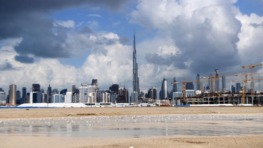 A picture taken on January 12, 2020 shows dark clouds over the skyline of Dubai with Burj Khalifa, the worlds tallest building. (Photo by KARIM SAHIB / AFP) (Photo by KARIM SAHIB/AFP via Getty Images)