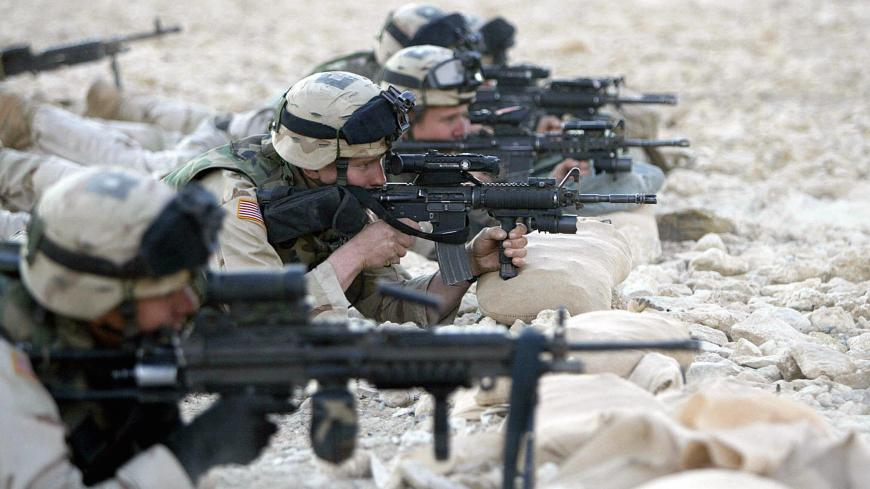 RAMADI, IRAQ: US soldiers take part in a shooting training in the restive city of Ramadi, 100 kms west of Baghdad, 02 December 2004. The United States announced plans to increase its forces in Iraq to their highest levels since last year's invasion, as the country's interim government engaged in a flurry of contacts to rally support for January 30 elections. AFP PHOTO/AHMAD AL-RUBAYE (Photo credit should read AHMAD AL-RUBAYE/AFP via Getty Images)