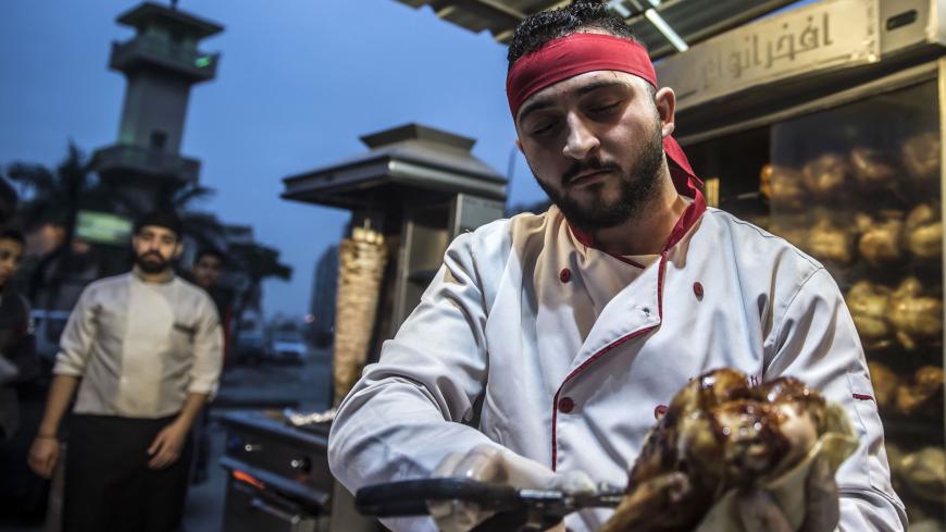 Syrian refugee Adel Bazmawi, 21, a co-founder and coach of the Syrian Sports Academy, works at a restaurant in Egypt's second city of Alexandria on January 4, 2018.
The academy is squeezed into just 30 square metres (320 square feet), in a modestly equipped hall at the bottom of a residential building in the Alexandria neighbourhood. The academy's founders began the project in 2016 with just 3,000 Egyptian pounds (about $430 at the time).
 / AFP PHOTO / KHALED DESOUKI        (Photo credit should read KHALED