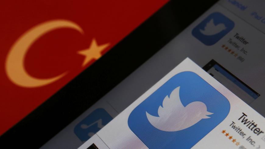 A Twitter logo on an iPad display is pictured next to a Turkish flag in this photo illustration taken in Istanbul March 21, 2014. Turkey's courts have blocked access to Twitter a little over a week before elections as Prime Minister Tayyip Erdogan battles a corruption scandal that has seen social media awash with alleged evidence of government wrongdoing. The ban came hours after a defiant Erdogan, on the campaign trail ahead of key March 30 local elections, vowed to "wipe out" Twitter and said he did not c