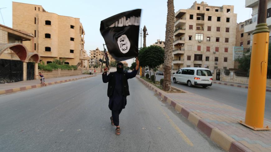 A member loyal to the Islamic State in Iraq and the Levant (ISIL) waves an ISIL flag in Raqqa June 29, 2014. The offshoot of al Qaeda which has captured swathes of territory in Iraq and Syria has declared itself an Islamic "Caliphate" and called on factions worldwide to pledge their allegiance, a statement posted on jihadist websites said on Sunday. The group, previously known as the Islamic State in Iraq and the Levant (ISIL), also known as ISIS, has renamed itself "Islamic State" and proclaimed its leader