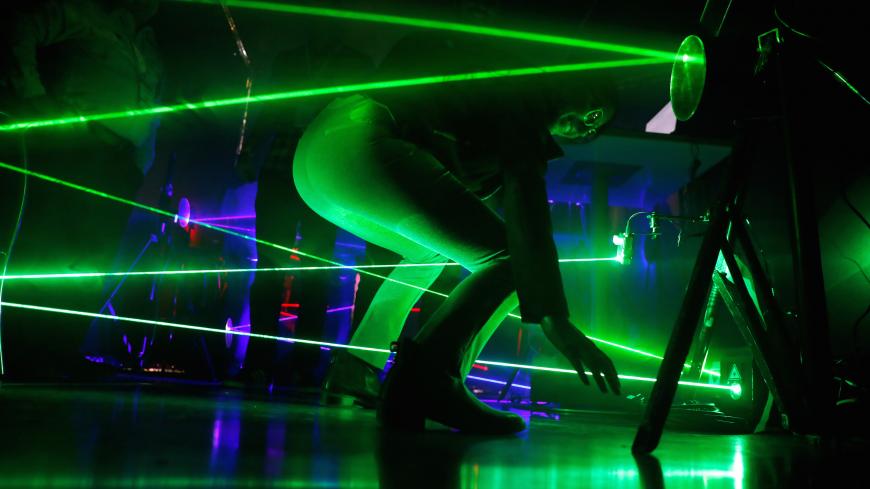 A visitor takes part in a challenge with laser beams at the Israeli police exhibition stand at the Cybertech 2019 conference in Tel Aviv, Israel January 29, 2019. REUTERS/Amir Cohen - RC15E862C4A0