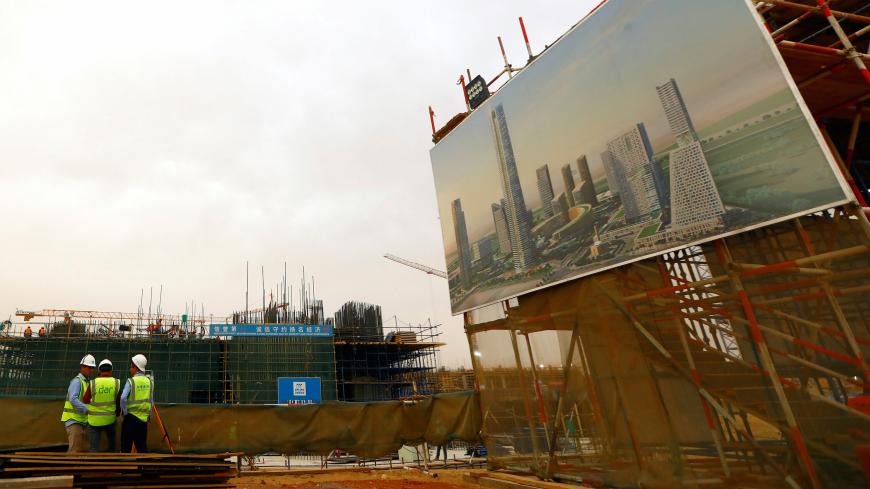 Chinese construction labourers work at the site of the future Iconic Tower skyscraper, at its foundations in the business district, being built by China State Construction Engineering Corp (CSCEC) in the New Administrative Capital (NAC) east of Cairo, Egypt May 2, 2019. Picture taken May 2, 2019. REUTERS/Amr Abdallah Dalsh - RC1DBF7311C0