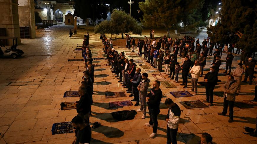 Worshippers pray on the compound housing al-Aqsa mosque, which is known to Muslims as the Noble Sanctuary and to Jews as the Temple Mount, as it reopened to worshippers after a two-and-a-half month closure due to the outbreak of the coronavirus disease (COVID-19), in Jerusalem's Old City May 31, 2020. REUTERS/Ammar Awad - RC2HZG9OOZMA