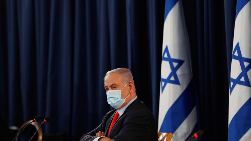 Israeli Prime Minister Benjamin Netanyahu wears a mask as he looks on during the weekly cabinet meeting in Jerusalem May 31, 2020. REUTERS/Ronen Zvulun - RC2LZG9EHLTK