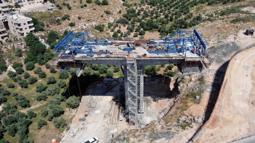 An aerial view shows a bridge under construction as part of The American Road, an Israeli ring road that is being built through East Jerusalem. The construction is in Sur Baher, a Palestinian neighbourhood of East Jerusalem May 10, 2020. Picture taken May 10, 2020. Picture taken with a drone. REUTERS/Ilan Rosenberg - RC2O9H9UGLEJ