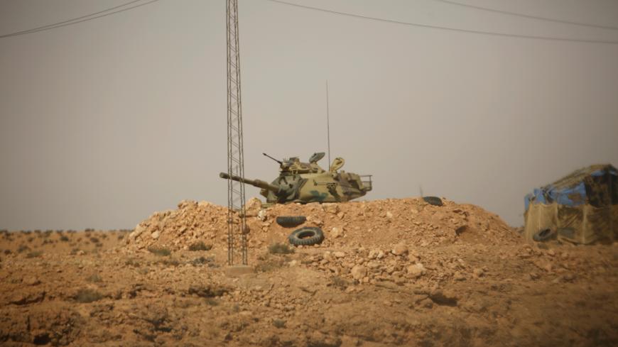A Tunisian security forces tank is seen through a car window at Dhiba by the Tunisian and Libyan border crossing, Tunisia April 11, 2016. Tunisia's 2011 uprising created fertile ground for jihadist recruiters. Hundreds of Islamist militants were freed from prison as part of an amnesty for those detained under Ben Ali. Ultra-conservative salafists began to flex their muscle, seizing control of mosques and clashing with secularists. As Tunisia's politics have stabilised, the government has reasserted control,