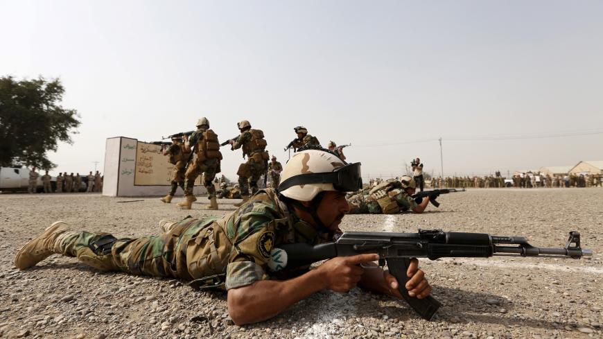 Iraqi security forces demonstrate their skills during a graduation ceremony at an Iraqi army base in Camp Taji in Baghdad, February 21, 2016. REUTERS/Ahmed Saad - GF10000317853