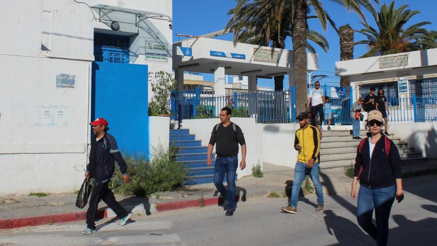 People leave a train station, as Tunisia relaxes some of its lockdown rules while keeping other restrictions in place, as preventive measures against the spread of the coronavirus disease (COVID-19), in La Marsa near Tunis, Tunisia May 11, 2020. REUTERS/Angus McDowall - RC2HMG9VLBYJ