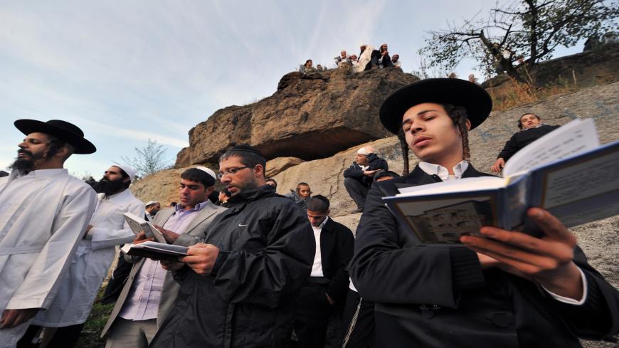 Khasids, ultra orthodox Jewish, pray in the small Ukrainian city of Uman, some 200 km (120 miles) south of Kiev on September 9, 2010. About 24,000 of followers of Rabbi Nachman from around the world flocked to the Uman to pay homage to their spiritual leader and celebrate the start of the New Year at his grave.    AFP PHOTO/ SERGEI SUPINSKY (Photo credit should read SERGEI SUPINSKY/AFP via Getty Images)