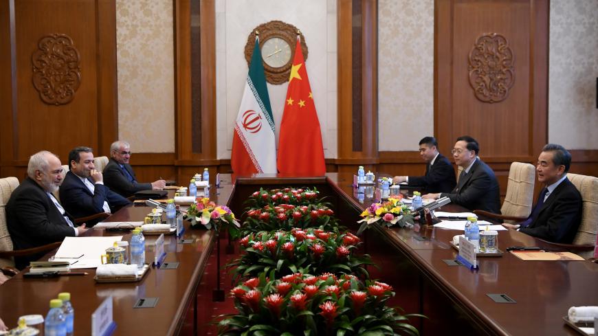 BEIJING, CHINA - DECEMBER 31: China's Foreign Minister Wang Yi talks to Iran's Foreign Minister Mohammad Javad Zarif during a meeting at the Diaoyutai state guest house on December 31, 2019 in Beijing, China. (Photo by Noel Celis - Pool/Getty Images)