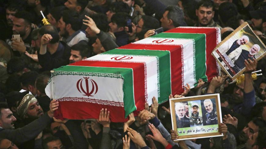 TOPSHOT - Mourners carry the coffins of slain Iraqi paramilitary chief Abu Mahdi al-Muhandis, Iranian military commander Qasem Soleimani and eight others inside the Shrine of Imam Hussein in the holy Iraqi city of Karbala,during a funeral procession on January 4, 2020. - Thousands of Iraqis chanting "Death to America" today as they mourned an Iranian commander and others killed in a US drone attack that sparked fears of a regional proxy war between Washington and Tehran. (Photo by Mohammed SAWAF / AFP) (Pho