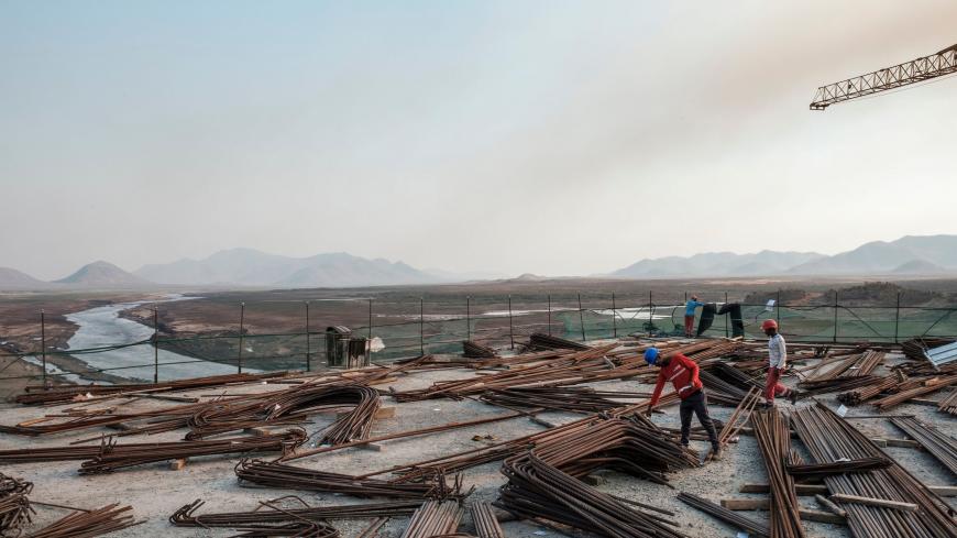 Kafule Yigzaw (L) check iron bars at the Grand Ethiopian Renaissance Dam (GERD), near Guba in Ethiopia, on December 26, 2019. - The Grand Ethiopian Renaissance Dam, a 145-metre-high, 1.8-kilometre-long concrete colossus is set to become the largest hydropower plant in Africa.
Across Ethiopia, poor farmers and rich businessmen alike eagerly await the more than 6,000 megawatts of electricity officials say it will ultimately provide. 
Yet as thousands of workers toil day and night to finish the project, Ethiop