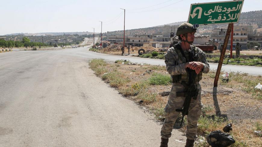 Turkish soldiers stand guard during a joint Russian-Turkish patrol along the M4 highway, which links the northern Syrian provinces of Aleppo and Latakia, near Ariha in Syria's rebel-held northwestern Idlib province, on June 10, 2020. (Photo by OMAR HAJ KADOUR / AFP) (Photo by OMAR HAJ KADOUR/AFP via Getty Images)