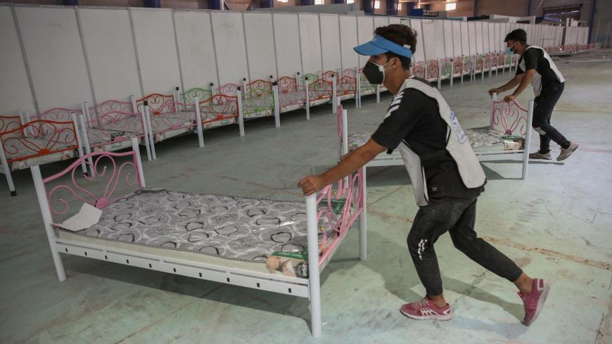 Iraqi volunteers with the Aqiq Institution for Charity work on building a 525-bed field hospital at the Baghdad International Fair exhibition center in the capital Baghdad, on June 21, 2020, a facility the association is setting up as part of the efforts to curb the spread of the COVID-19 pandemic. (Photo by AHMAD AL-RUBAYE / AFP) (Photo by AHMAD AL-RUBAYE/AFP via Getty Images)