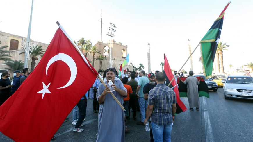 People wave flags of Libya (R) and Turkey (L) during a demonstration in the Martyrs' Square in the centre of the Libyan capital Tripoli, currently held by the UN-recognised Government of National Accord (GNA), on June 21, 2020. - The GNA on June 21 denounced Egypt's warning of military intervention in Libya, labelling it a "declaration of war", after the Egyptian President warned that if pro-GNA forces advanced on the strategic city of Sirte -- some 450 kilometres (280 miles) east of Tripoli -- it could pro