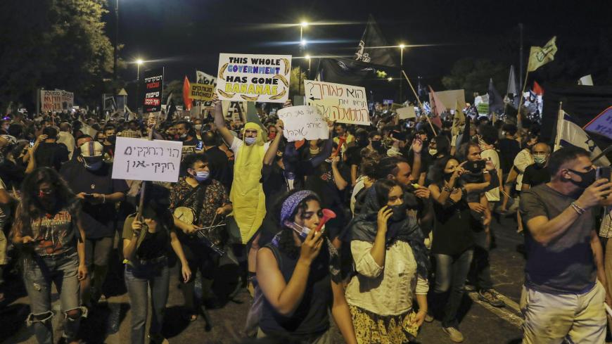 Israelis protest against Israeli Prime Minister Benjamin Netanyahu in Jerusalem, on July 21, 2020. - Netanyahu, 70, was indicted in January for bribery, fraud and breach of trust in three cases. He denies all the charges and accuses the media and legal officials of a witch hunt. (Photo by Ahmad GHARABLI / AFP) (Photo by AHMAD GHARABLI/AFP via Getty Images)