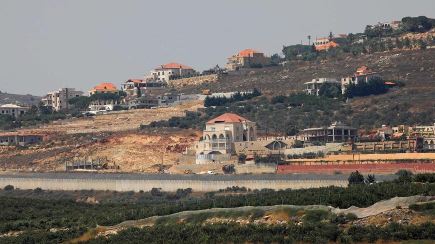 A picture taken from the northern Israeli town of Metula shows the southern Lebanese village of Kfar Kila behind the concrete barrier wall along the border between the two countries, on July 28, 2020. - Israel said it had repelled an attempt by Hezbollah fighters to penetrate its northern border on July 27, but the Lebanese group denied any involvement in the incident.
The border clash, which Israel said included an exchange of fire between its troops and gunmen, followed days of reported heightened tensi