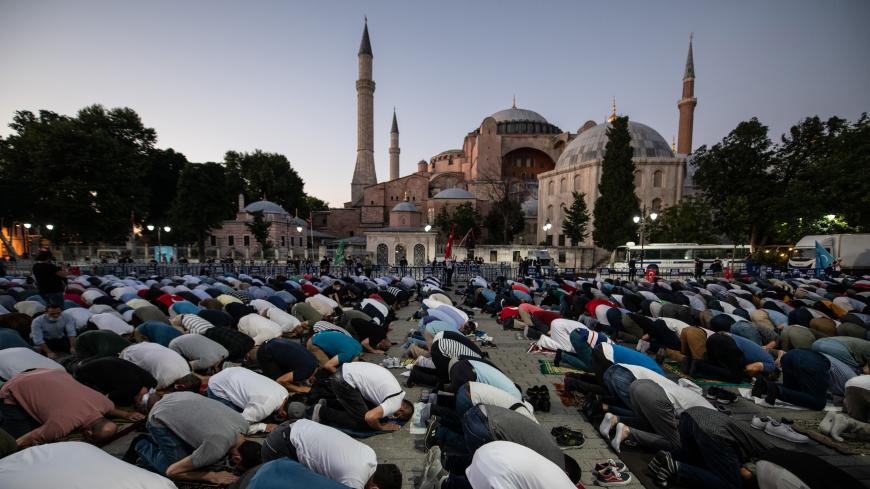 ISTANBUL, TURKEY - JULY 10: People gather for evening prayers outside Istanbul's famous Hagia Sophia on July 10, 2020 in Istanbul, Turkey. Turkey's top administrative court ruled to annul a 1934 decree that turned the historic Hagia Sophia into a museum. The controversial ruling opens the way for the structure to be converted back into a mosque after 85 years. President Recep Tayyip Erdoƒüan handed over the iconic structure‚Äôs control to the country‚Äôs Religious Affairs Directorate following a court rulin