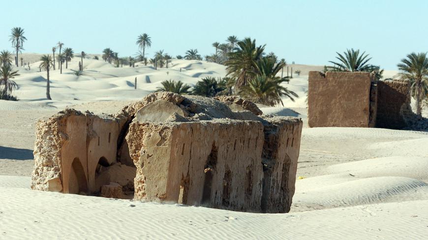 DOUZ, TUNISIA:  An abandoned Berber village sits in dunes in the vicinity of Zaafarane, near the southern Tunisian town of Douz, 24 December 2006 as the 39th International Sahara Festival opens. The festival, held 600 kms (370 miles) south of Tunis, draws locals and tourists for a cultural event that celebrates the region's heritage and desert people. AFP PHOTO FETHI BELAID  (Photo credit should read FETHI BELAID/AFP via Getty Images)