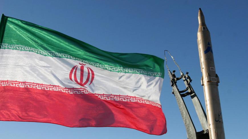 An Iranian flag flutters next to a ground-to-ground Sajil missile before being launched at an undisclosed location in Iran on November 12, 2008. Iran test fired today a new generation of ground-to-ground missile, the semi-official Fars news agency quoted the defence minister as saying. In the past Iran has often boasted of developing new weapons systems only to be met with scepticism from Western defence analysts. AFP PHOTO/FARS NEWS/STR (Photo credit should read -/AFP via Getty Images)