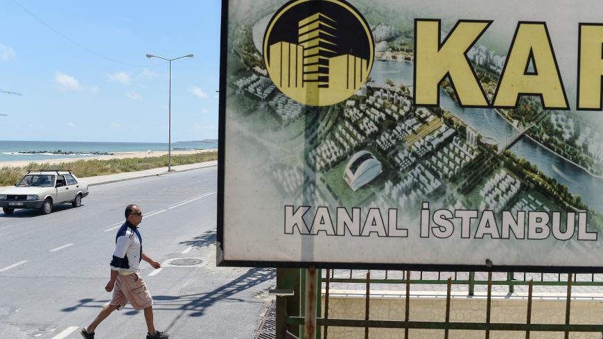 A real estate advertising offers apartments with the view on the canal, in the small coastal village of Karaburun, near Istanbul, on June 12, 2018. - Karaburun's residents are waiting if a controversial new canal that will be built for Istanbul will change the region for the good. The ambitious Canal Istanbul project, first announced by Turkish current President in 2011 when he was prime minister, would begin in the Istanbul district of Kucukcekmece and then head toward Sazlidere reservoir before emerging i