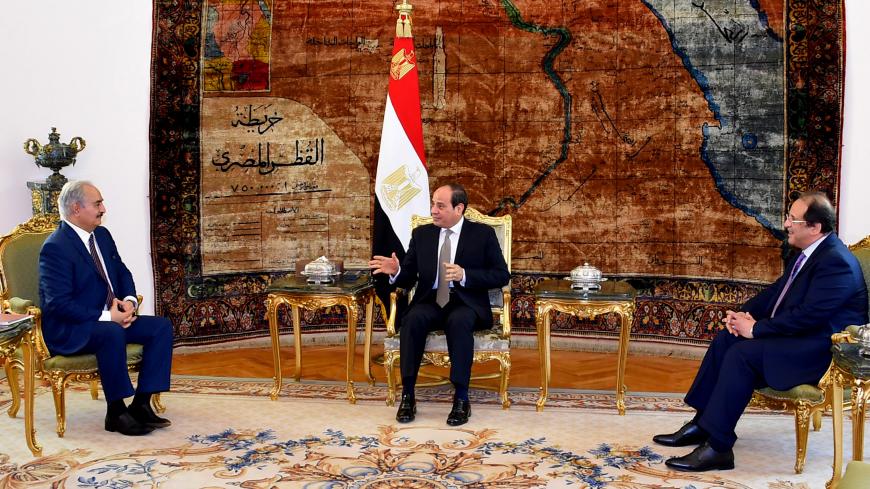This handout picture released by the Egyptian Presidency on April 14, 2019, shows Egyptian president Abdel Fattah al-Sisi (C) and intelligence chief Abbas Kamel (R) meeting Libyan strongman Khalifa Haftar (L) at the Ittihadia presidential Palace in the capital Cairo. - Egyptian President Abdel Fattah al-Sisi met Sunday with Libyan commander Khalifa Haftar whose forces are fighting for control of the capital Tripoli, state media reported. Sisi has been an ardent supporter of Haftar's forces, which control sw