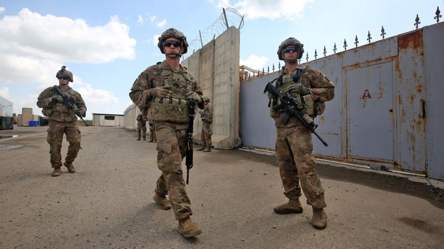US army soldiers, part of the Combined Joint Task Force  Operation Inherent Resolve (CJTF-OIR) the US-led coalition against the Islamic State (IS) group, walk around at the K1 Air Base northwest of Kirkuk in northern Iraq before a planned US pullout on March 29, 2020. (Photo by AHMAD AL-RUBAYE / AFP) (Photo by AHMAD AL-RUBAYE/AFP via Getty Images)