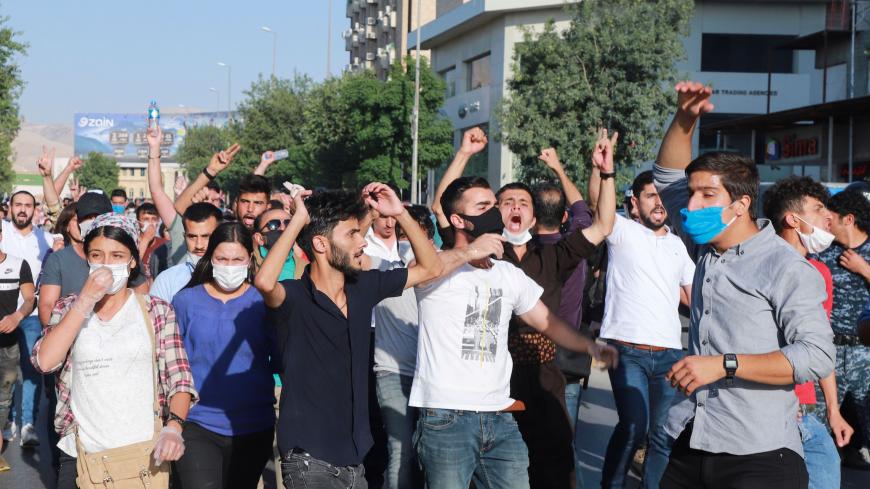 Iraqi kurds, some of them wearing protective masks due to COVID-19, march during a demonstration to denounce the Turkish assault in northern Iraq, in Sulaimaniyah city, in the Kurdish autonomous region of northern Iraq, on June 18, 2020. - Turkey launched a rare ground assault into northern Iraq on June 17, deploying special forces against rebels from the Kurdistan Workers' Party (PKK) which is blacklisted by Ankara as a "terrorist" group. Baghdad demanded Ankara immediately halt its assault in northern Ira
