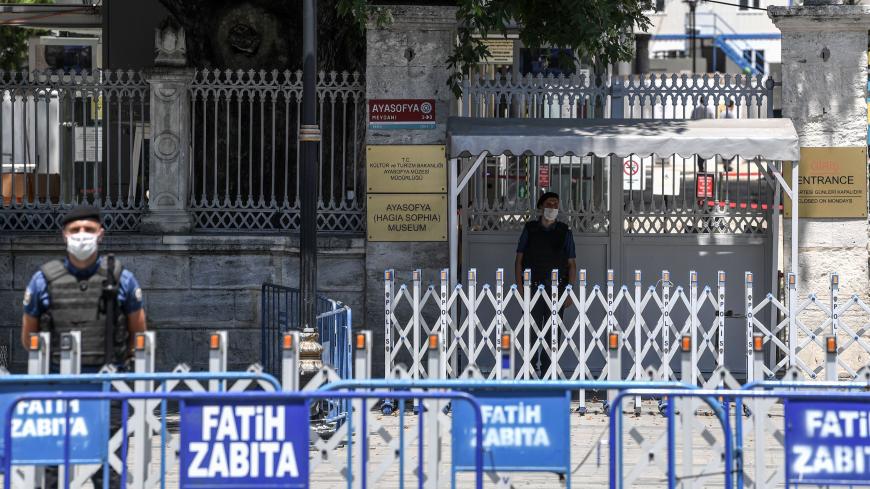 Turkish police officers wearing face masks stand in front of Hagia Sophia entrance on July 11, 2020 in Istanbul, a day after a top Turkish court revoked the sixth-century Hagia Sophia's status as a museum, clearing the way for it to be turned back into a mosque. - The United States said on July 10, it was "disappointed" by Turkey's decision to turn the Byzantine-era monument Hagia Sophia back into a mosque and urged equal access for all visitors. (Photo by Ozan KOSE / AFP) (Photo by OZAN KOSE/AFP via Getty 