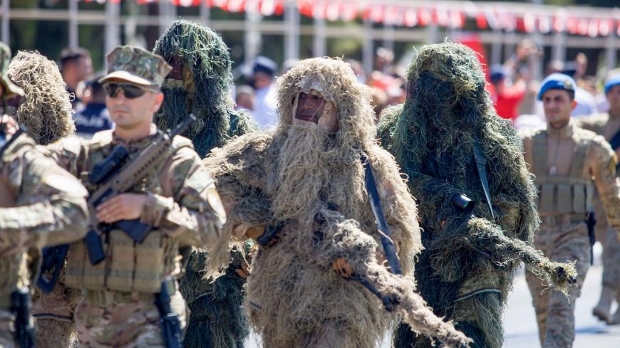 TOPSHOT - Turkish troops parade in the northern part of Nicosia, the capital of the self-proclaimed Turkish Republic of Northern Cyprus (TRNC) on July 20, 2020, to mark the 46th anniversary of the Turkish invasion of northern Cyprus in 1974. - The republic was created after Turkey invaded northern Cyprus in 1974 following a Greek Cypriot coup aimed at uniting the east Mediterranean island with Greece. Cyprus has remained divided since. (Photo by Birol BEBEK / AFP) (Photo by BIROL BEBEK/AFP via Getty Images)