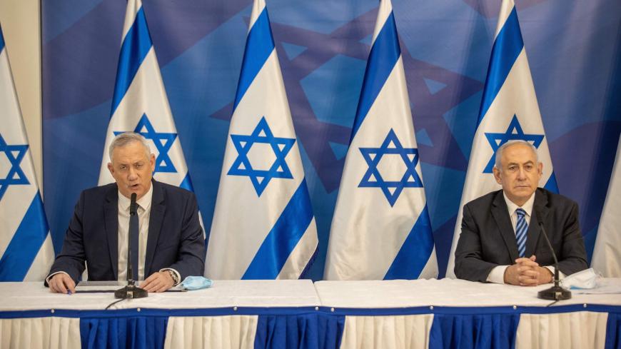 Israeli Prime Minister Benjamin Netanyahu (R) and alternate Prime Minister and Defence Minister Benny Gantz (L) issue a statement at the Israeli Defence Ministry in Tel Aviv on July 27, 2020 following the high tensions with the Lebanese militant group Hezbollah at the Israeli-Lebanon border. (Photo by Tal SHAHAR / POOL / AFP) (Photo by TAL SHAHAR/POOL/AFP via Getty Images)