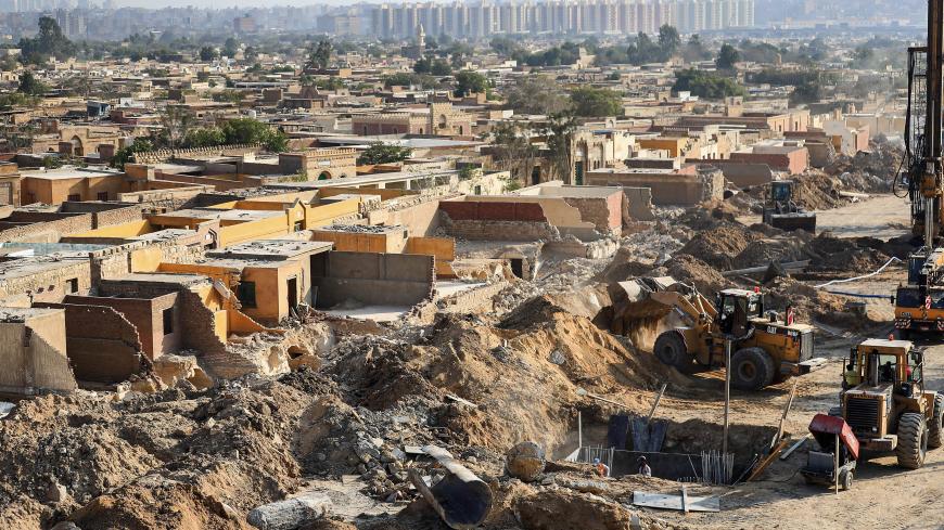 This picture taken on July 22, 2020 shows a view of ongoing demolitions of graveyards and construction work for a new flyover bridge passing through the Basatin cemetery, south of historic old Cairo. - Egyptian mother-of-three Menna was caught off guard when a bulldozer clearing space for a controversial highway flattened much of a mausoleum that doubled as her home in a Cairo 7th century Islamic necropolis. Her parents and grandparents had made their home among the graves of the City of the Dead, where bur