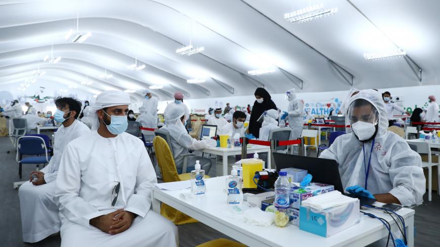ABU DHABI, UNITED ARAB EMIRATES - AUGUST 10:  A man waits for his test results after being tested with Laser-based DPI technology at a testing center at the Dubai-Abu Dhabi border on August 10, 2020 in Abu Dhabi, United Arab Emirates. The UAE has recorded around 62,000 cases of covid-19, with 357 deaths, among its population of 9.6 million people. New cases have steadily declined since a spike at the beginning of July. (Photo by Francois Nel/Getty Images)