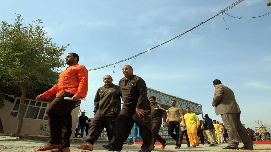 Iraqi detainees leave the prison after being freed on February 28, 2013 in the Iraqi capital Baghdad. 160 prisoners were freed today and Iraq has freed 4,000 prisoners since the beginning of 2013, Deputy Prime Minister Hussein al-Shahristani said Thursday, in an apparent bid to placate protesters in Sunni areas of the country.  AFP/ PHOTO/ ALI AL-SAADI        (Photo credit should read ALI AL-SAADI/AFP via Getty Images)