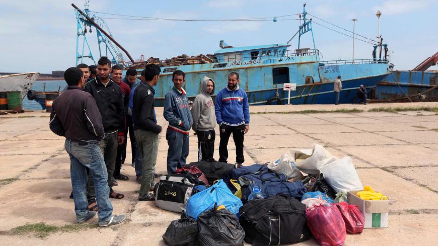 Egyptian fishermen, who had entered the Libyan waters with out permission, gather at the port in the Libyan city of Misrata on April 2, 2015, following the order of their release after three months in detention. A Libyan maritime official said the release came after coordinating with their families and Egyptian authorities. AFP PHOTO / MAHMUD TURKIA (Photo credit should read MAHMUD TURKIA/AFP via Getty Images)